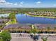 Charming two-story townhomes with lake view, enhanced by mature trees, and convenient parking at 12983 Tigers Eye Dr, Venice, FL 34292
