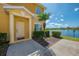 Inviting front entrance with well-maintained landscaping and a peaceful lake view at 12983 Tigers Eye Dr, Venice, FL 34292
