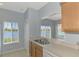A kitchen area with a lake view framed by windows, adjacent to the sink and countertop at 12983 Tigers Eye Dr, Venice, FL 34292