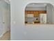 Pass through view of a kitchen featuring wood cabinets and modern appliances at 12983 Tigers Eye Dr, Venice, FL 34292