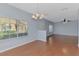 Bright living area featuring laminate floors, neutral paint, and a large window at 12983 Tigers Eye Dr, Venice, FL 34292