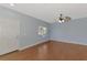 Spacious living room with laminate floors, fan, neutral paint, and a front door at 12983 Tigers Eye Dr, Venice, FL 34292
