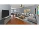 Inviting living room with hardwood floors, a comfortable sectional, and abundant natural light at 12983 Tigers Eye Dr, Venice, FL 34292