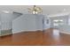 Spacious living room with hardwood floors and natural light, adjacent to a staircase and dining area at 12983 Tigers Eye Dr, Venice, FL 34292