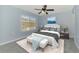 Serene bedroom with a plush bed, soft lighting, and a window offering a pleasant outdoor view at 12983 Tigers Eye Dr, Venice, FL 34292