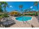 A community pool with a cabana and lounge chairs at 12983 Tigers Eye Dr, Venice, FL 34292