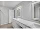 Bright bathroom featuring double vanity with white cabinets, light counter, and decorative framed mirrors at 131 Sandstone Cir, Venice, FL 34293