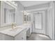 Bathroom featuring double vanity with marble countertop, modern fixtures, and a door to the exterior at 131 Sandstone Cir, Venice, FL 34293