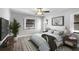 Cozy bedroom featuring wood-look flooring, neutral paint, ceiling fan, and a decorative rug at 131 Sandstone Cir, Venice, FL 34293