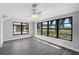 Bedroom with views of the canal through large windows and gray wood floors at 131 Sandstone Cir, Venice, FL 34293