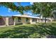 Charming home featuring a well-maintained lawn and mature trees offering shade in a desirable neighborhood at 131 Sandstone Cir, Venice, FL 34293
