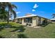 Charming home featuring a well-maintained lawn and mature palm trees in a desirable neighborhood at 131 Sandstone Cir, Venice, FL 34293