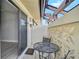 Covered patio with tiled floor and a table and chairs, connected to the living room at 131 Sandstone Cir, Venice, FL 34293