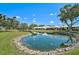 Beautiful water view in community, featuring lush landscaping and well-maintained grounds at 131 Sandstone Cir, Venice, FL 34293