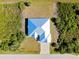 Bird's eye view of home with a blue and white roof, showcasing the surrounding landscape at 13452 High Springs Ave, Port Charlotte, FL 33981