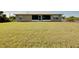 Expansive backyard featuring a well-maintained lawn extending from the house, perfect for outdoor activities and relaxation at 13452 High Springs Ave, Port Charlotte, FL 33981