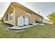 Exterior view of home and propane tanks with beautiful backyard at 13452 High Springs Ave, Port Charlotte, FL 33981