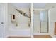 Clean bathroom featuring a soaking tub and glass-enclosed shower at 13452 High Springs Ave, Port Charlotte, FL 33981