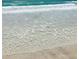 Calm turquoise waters gently lapping onto a pristine white sand beach, ideal for relaxation and recreation at 13452 High Springs Ave, Port Charlotte, FL 33981