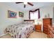 Cozy bedroom featuring floral bedding, wood furniture, a window and unique decor at 13452 High Springs Ave, Port Charlotte, FL 33981