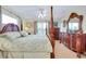 Comfortable bedroom displaying a four-poster bed, dresser, and large window at 13452 High Springs Ave, Port Charlotte, FL 33981