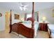 Spacious bedroom features a four-poster bed with decorative lamps on matching nightstands at 13452 High Springs Ave, Port Charlotte, FL 33981