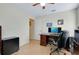 Bedroom featuring tile floors, a ceiling fan, and a desk with a computer monitor at 13452 High Springs Ave, Port Charlotte, FL 33981