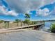 Community boat ramp with sturdy wooden planks under a cloudy blue sky offers boating enthusiasts easy access to the water at 13452 High Springs Ave, Port Charlotte, FL 33981