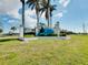 The South Gulf Cove community sign, adorned with lush landscaping and clear blue skies, invites residents and visitors alike at 13452 High Springs Ave, Port Charlotte, FL 33981