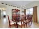 Elegant dining room featuring a large wooden table, matching chairs, china cabinet, and a chandelier at 13452 High Springs Ave, Port Charlotte, FL 33981