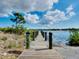 Picturesque wooden dock extending into a tranquil lake, offering stunning views and a serene atmosphere at 13452 High Springs Ave, Port Charlotte, FL 33981
