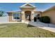 Inviting home front door with decorative glass, sidelights, and manicured landscaping at 13452 High Springs Ave, Port Charlotte, FL 33981