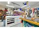 Functional garage space featuring a table saw, ample storage, and a well-lit workspace at 13452 High Springs Ave, Port Charlotte, FL 33981