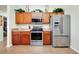 Modern kitchen featuring stainless steel appliances, wooden cabinets, and ample counter space for easy cooking at 13452 High Springs Ave, Port Charlotte, FL 33981