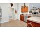 Bright kitchen featuring wooden cabinets, stainless steel appliances, and a tile floor with an open doorway at 13452 High Springs Ave, Port Charlotte, FL 33981