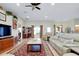 Open-concept living room featuring tile floors, comfortable seating, and view to lanai at 13452 High Springs Ave, Port Charlotte, FL 33981