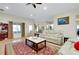 Inviting living room featuring comfortable seating, tile flooring, a ceiling fan, and natural light at 13452 High Springs Ave, Port Charlotte, FL 33981
