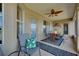 Inviting covered patio with decorative ceiling fan and furniture provides an ideal outdoor living space at 13452 High Springs Ave, Port Charlotte, FL 33981