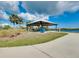 Open-air pavilion with picnic tables overlooking a serene lake, perfect for outdoor gatherings and relaxation at 13452 High Springs Ave, Port Charlotte, FL 33981