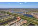 Beautiful aerial view of a waterfront community with meticulously landscaped homes and inviting water features at 13897 Umbria St, Venice, FL 34293