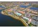 A community clubhouse featuring an outdoor pool, tennis courts, and beautifully maintained grounds with lake views at 13897 Umbria St, Venice, FL 34293