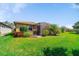 Lush backyard featuring a well-maintained lawn and a screened patio, perfect for outdoor relaxation at 13897 Umbria St, Venice, FL 34293