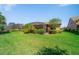 Manicured backyard featuring lush green grass and screened lanai offering a private outdoor space at 13897 Umbria St, Venice, FL 34293