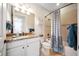 Bathroom features a granite vanity, tub with shower, and beige tile flooring at 13897 Umbria St, Venice, FL 34293
