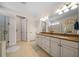 Bright bathroom with double vanity, granite countertops, and tile flooring at 13897 Umbria St, Venice, FL 34293