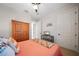 Bedroom featuring a bed with colorful pillows, wood wardrobe, ceiling fan, and carpet floors at 13897 Umbria St, Venice, FL 34293