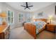Bright bedroom featuring neutral walls, carpet floors, a ceiling fan, and windows with plantation shutters at 13897 Umbria St, Venice, FL 34293