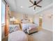 Serene bedroom featuring a ceiling fan, tray ceiling, sitting area, and ensuite bathroom at 13897 Umbria St, Venice, FL 34293