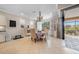A cozy dining area featuring tile floors, a chandelier, and natural light, adjacent to a screened patio at 13897 Umbria St, Venice, FL 34293