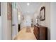 Inviting foyer with tile flooring, a decorative mirror, and a classic wooden dresser at 13897 Umbria St, Venice, FL 34293